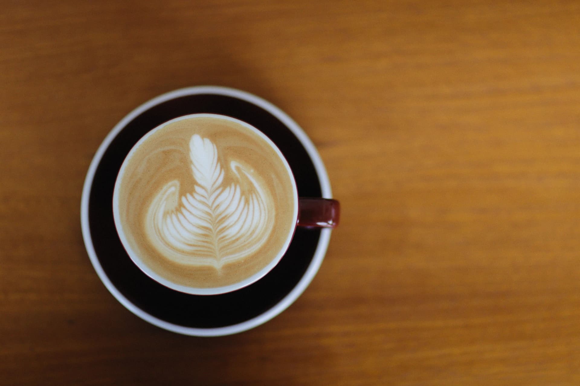 Beautifully crafted cappuccino with intricate latte art viewed from above