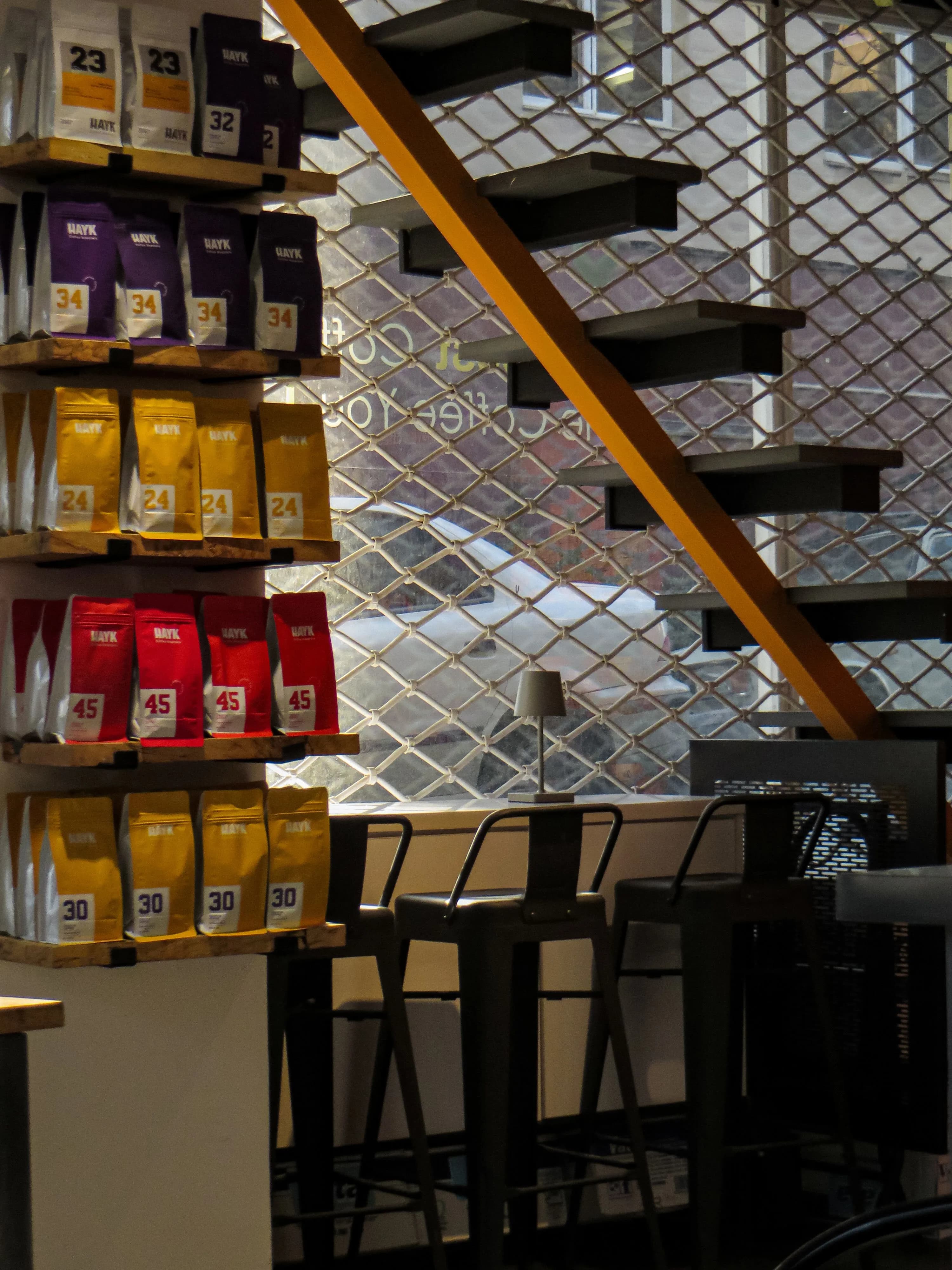 Cozy modern coffee shop interior with sleek black stools at Oksigen Coffee