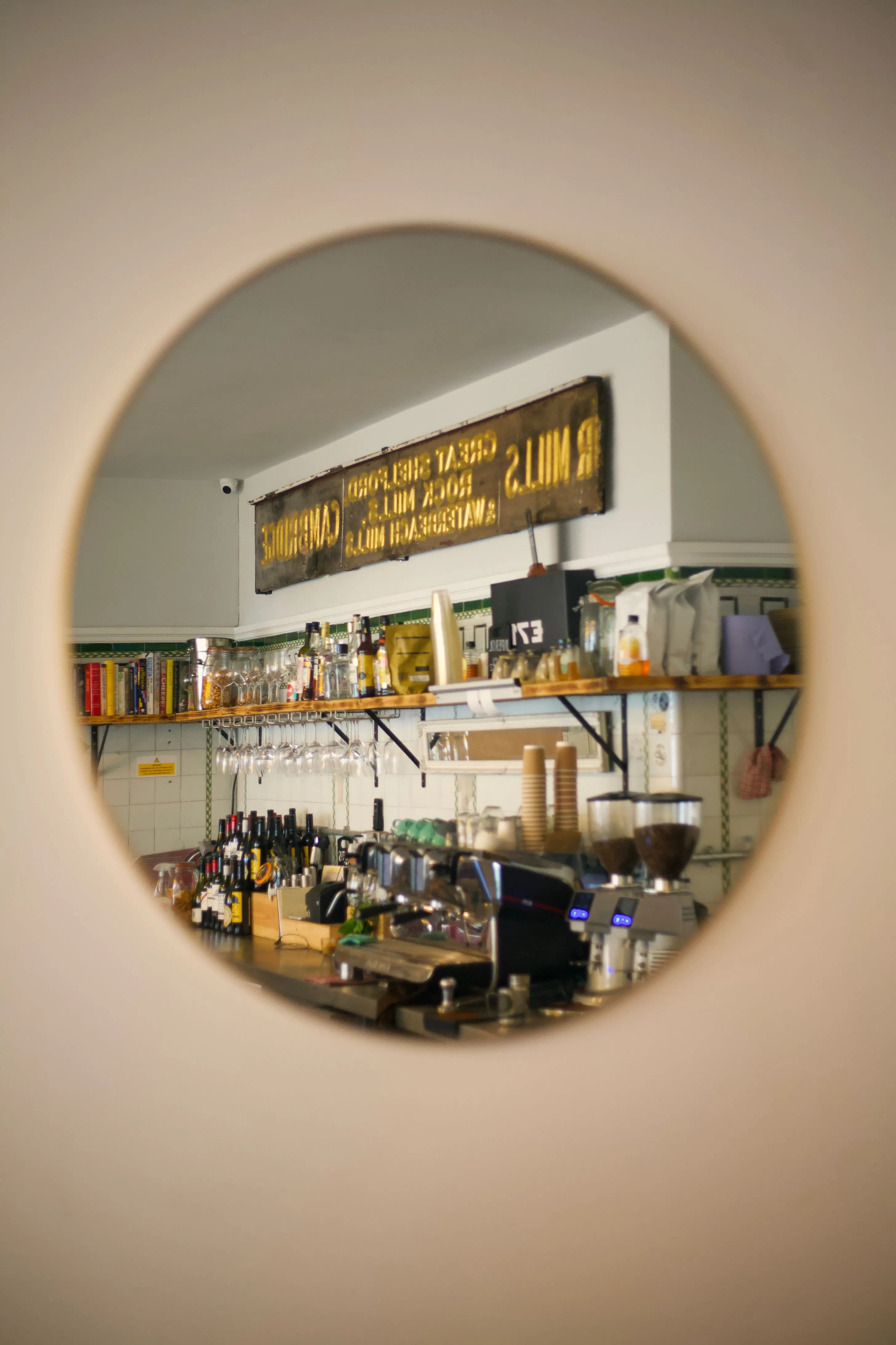 Cozy cafe interior with vintage design reflected in round mirror